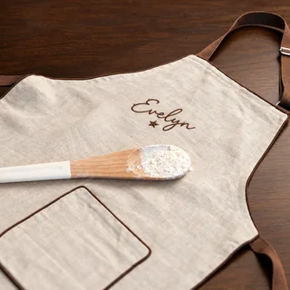 A child’s apron with the name Evelyn stitched on