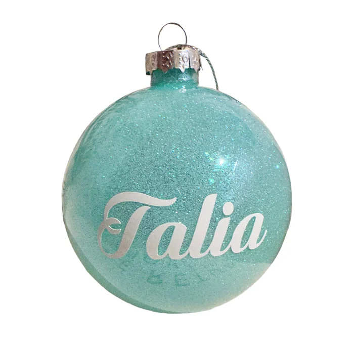 A turquoise glitter bauble with the name Talia in silver