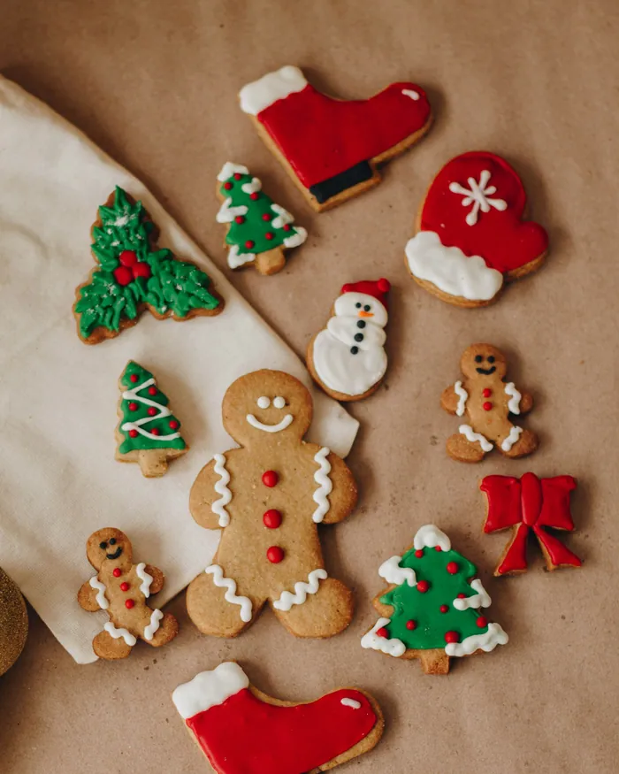 Iced Christmas biscuits in red, green and white: stockings, mittens, trees and a gingerbread man