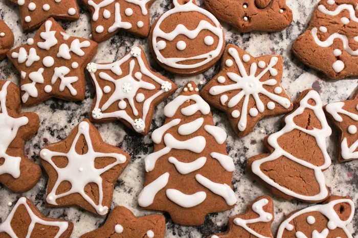 Gingerbread snowflakes, stars and a Christmas tree piped with white icing