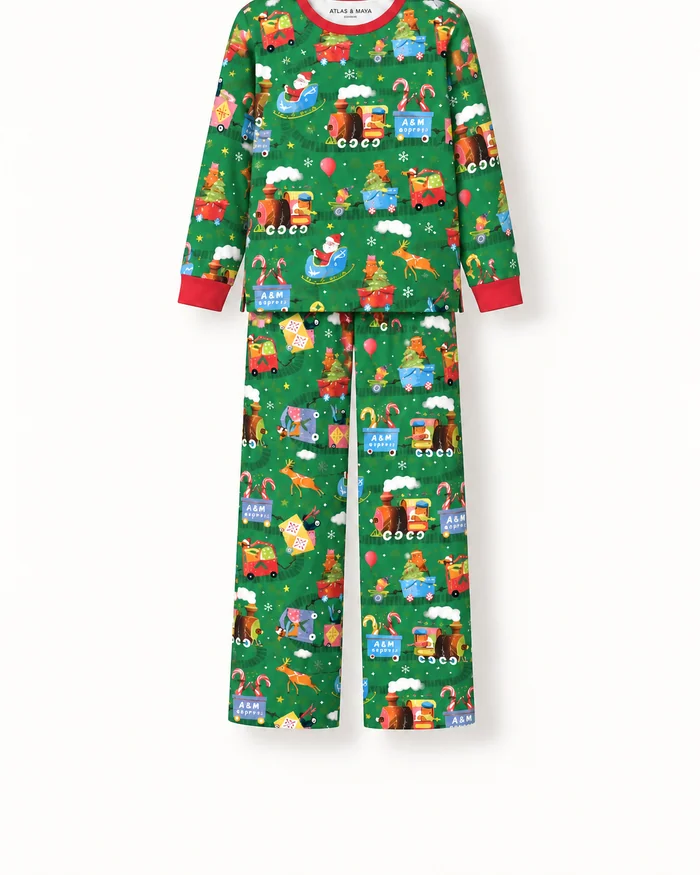 A child's green Christmas pyjama set printed with trains and presents
