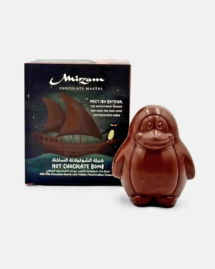 A Mirzam hot chocolate bomb gift box beside a chocolate penguin