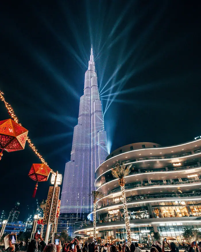 A tall Christmas tree dressed in red, gold and ribbon outside a shopping centre in Dubai