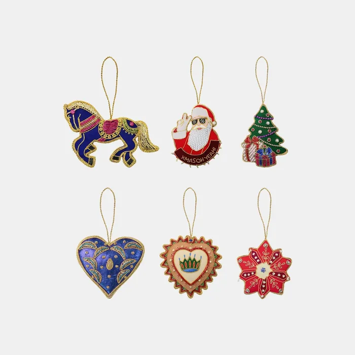 Six embroidered Christmas ornaments: a horse, Father Christmas, a tree, two hearts and a star