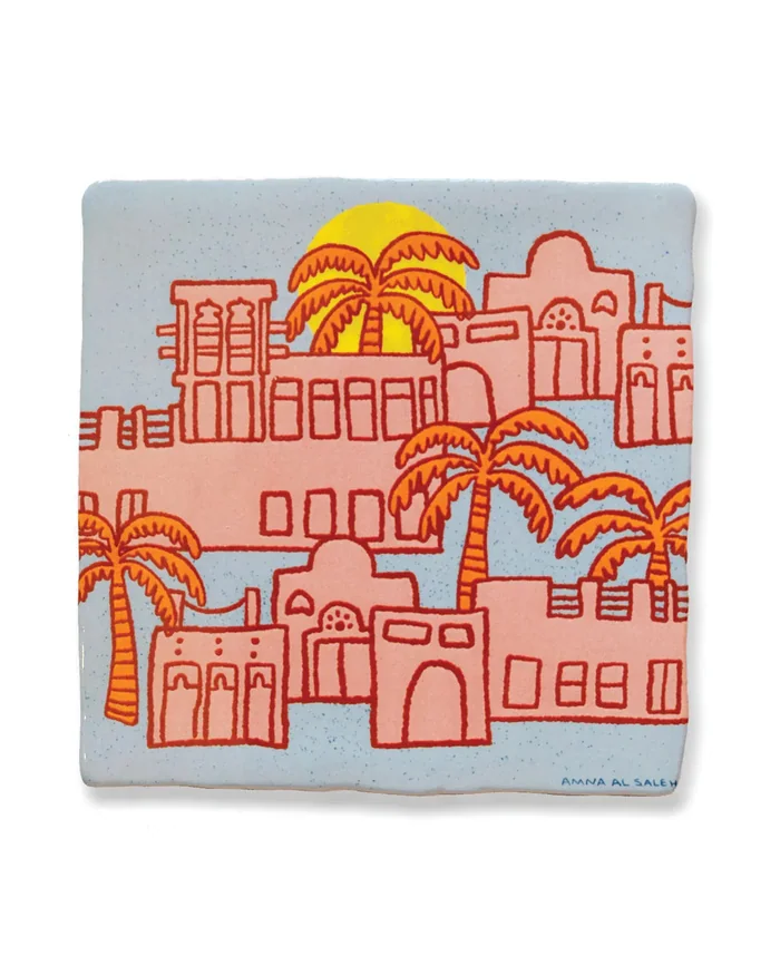 A painted tile showing pink houses and palm trees under a yellow sun