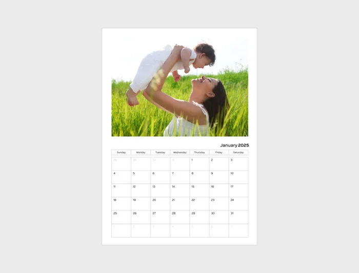 A wall calendar with a family photograph above the month grid