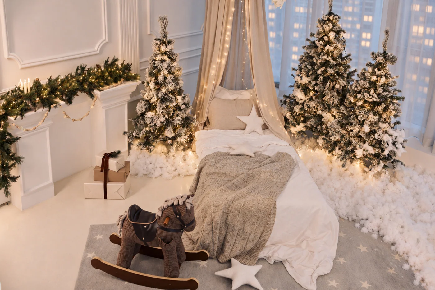 A children's room for Christmas morning: a bed under a cream canopy between frosted trees, a rocking horse on the rug