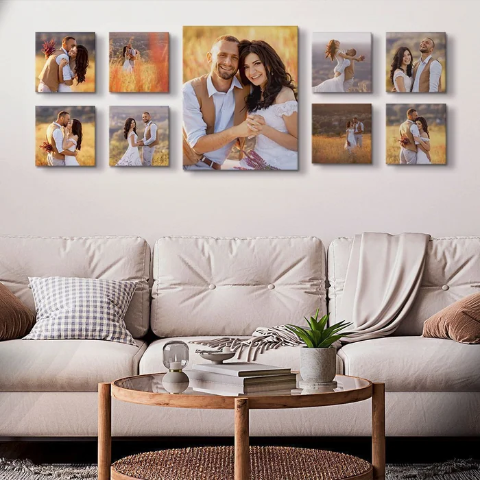 A wall of family photographs printed on canvas above a cream sofa and a coffee table