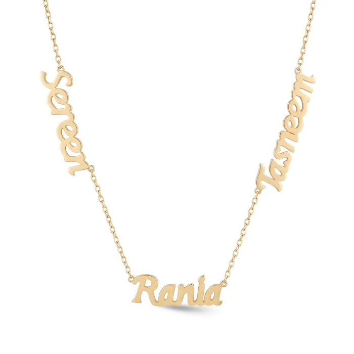 A gold necklace with three names in script