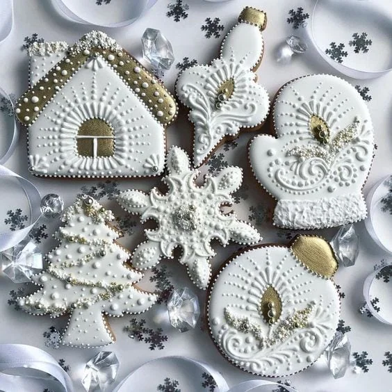 Iced Christmas biscuits shaped as a house, a tree, a snowflake, a mitten and baubles