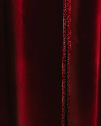 A deep burgundy velvet curtain falling in soft folds